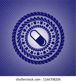 pill icon inside denim background