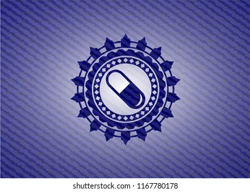 pill icon inside denim background