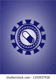 pill icon inside denim background