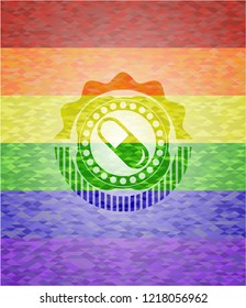 pill icon inside emblem on mosaic background with the colors of the LGBT flag