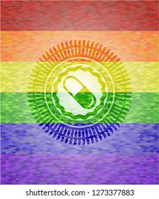 pill icon inside emblem on mosaic background with the colors of the LGBT flag
