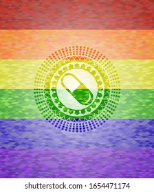 pill icon inside emblem on mosaic background with the colors of the LGBT flag
