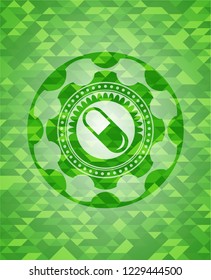 pill icon inside green emblem with triangle mosaic background