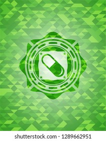 pill icon inside green mosaic emblem