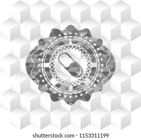 pill icon inside grey badge with geometric cube white background