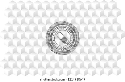 pill icon inside grey emblem with cube white background