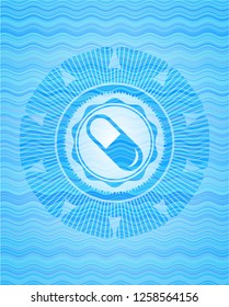 pill icon inside light blue water wave style badge.