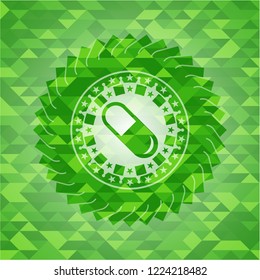 pill icon inside realistic green emblem. Mosaic background