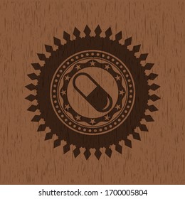 Icono de píldora dentro del emblema de madera estilo retro