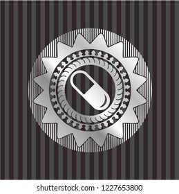 pill icon inside silver emblem
