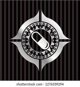 pill icon inside silver emblem
