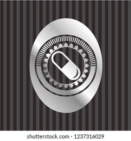 pill icon inside silvery emblem or badge