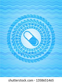 pill icon inside sky blue water style badge.