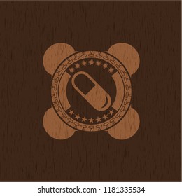 pill icon inside vintage wood emblem