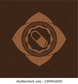 pill icon inside vintage wooden emblem