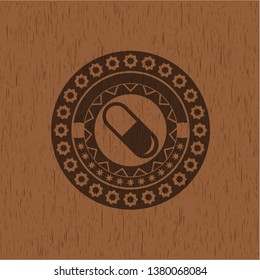 pill icon inside wood badge or emblem