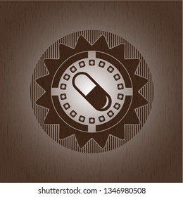 pill icon inside wood emblem. Retro