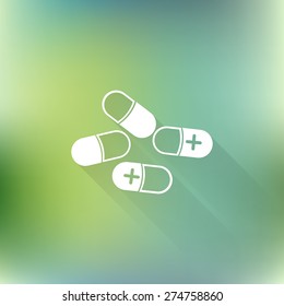Pills and capsules icon, vectors symbol with long shadow on blurred background