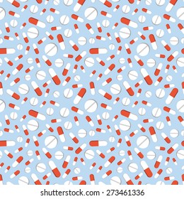 A lot of pills on blue background seamless pattern