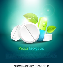 Pills and tablets with leaves on blue background - health concept