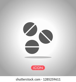 Pills or vitamins. Simple icon. Icon under spotlight. Gray background