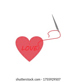 Pincushion in the shape of a heart with the inscription love