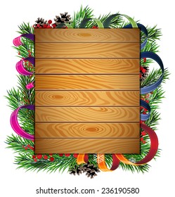 Pine branches, ribbons and red berries on wooden board.
