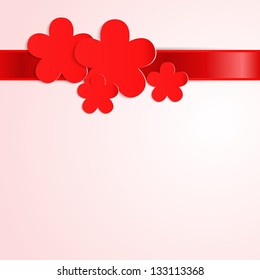 Pink background with red paper flowers and red ribbon