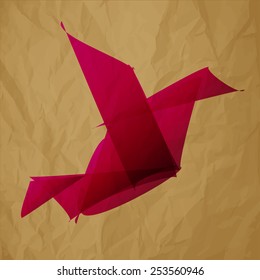 pink bird origami on crumpled paper brown background