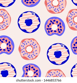 Donuts rosas y azules en un diseño de patrones sin fisuras, que se pueden utilizar tanto en la web como en la impresión para el diseño de superficies
