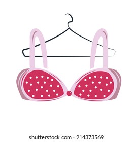 a pink bra with some dots and details on a white background