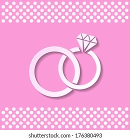 Pink card with white wedding rings with shadow