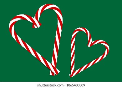 Pink christmas candy on green background. Xmas festive background. Love symbol. Stock image.