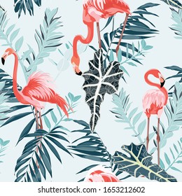 Pink flamingo and exotic blue leaves, blue background. Floral seamless pattern. Tropical illustration. Exotic plants, birds. Summer beach design. Paradise nature.