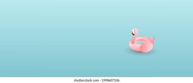 Pink flamingo inflatable circle on a gentle blue background with copy space