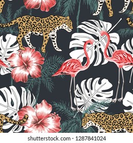Pink flamingo, leopard, palm trees, red hibiscus flowers, black background. Vector seamless pattern. Tropical illustration. Exotic animals and birds. Summer beach design. Paradise nature