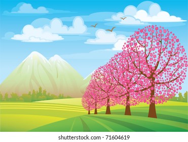 Pink flowering tree on a green meadow, mountains and blue sky
