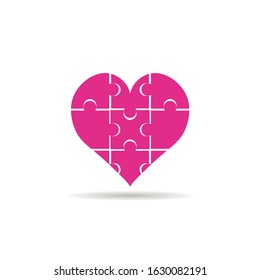 Pink heart in the form of a puzzle with shadow