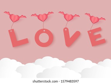 pink heart shape with wings and love word over cloud vector background