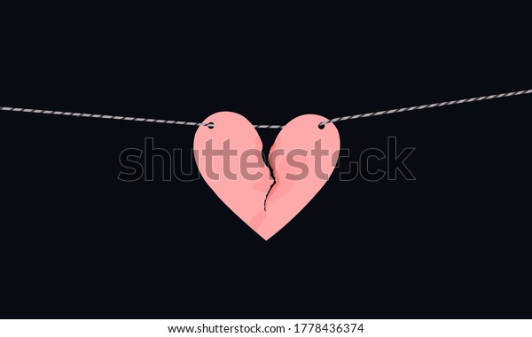 Pink heart shaped paper with torn\
marks hanging on the rope. Broken heart,unrequited\
love.