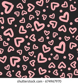 Pink hearts and dots randomly scattered on a black background. Seamless pattern. Grunge, sketch, graffiti, rough brush. Vector illustration.