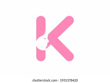 Pink K initial letter with silhouette of women face design