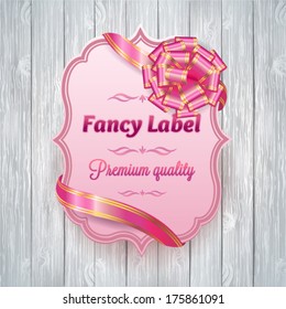 Pink label with ribbon bow. Vector illustration