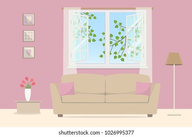 Pink living room. Beige sofa with pillows on an open window background. Outside the window there are tree branches with leaves. There is a lamp, a table with tulips and pictures in the room. Vector
