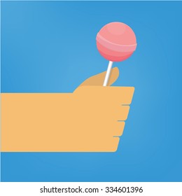 Pink lollipop in hand