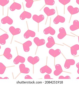 Los corazones de la pala rosada. Patrón vectorial sin fisuras con lollipops.