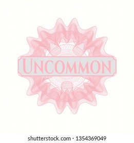 Pink money style rosette with text Uncommon inside