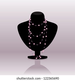Pink necklace on black mannequin isolated on a light background
