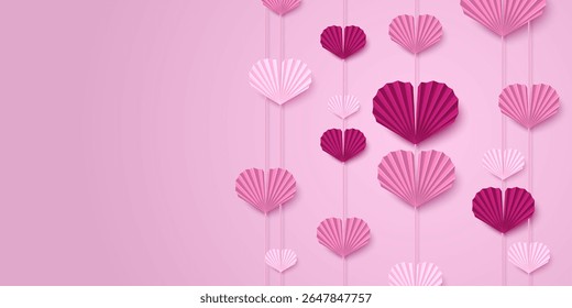Pink paper heart garland backdrop with hanging folded fan decorations in light pink and magenta colors. Valentine Day romantic display with multiple strings of origami style for wedding or party decor
