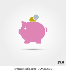 pink piggy bank with coins